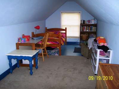 These are current views of the two bedrooms upstairs.  This first group of photos are all of one bedroom that's shaped sort of like a T, with 3 separate wings.  Currently, our 3 grandchildren share this big (580 sq. ft) room.  This picture shows the oldest granddaughter's wing, set up as a mini apt.