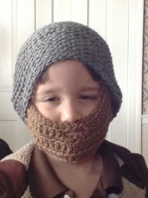 A co-worker of mine sent me a picture of a hat similar to this (made for adult men) and asked if I could make one for a 3-yr-old friend of his family's.  The chin part was specifically made brown to give the impression of a beard.  I used Ryan as my model to see if the size seemed appropriate (for a 3-yr-old) even though Ryan just turned 6.