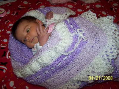 Our 2-week-old granddaughter in her specially-made blanket.