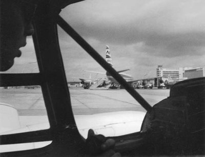 1962 - taxiing to the gate past a Northeast Airlines Convair 880 on Concourse 3 at MIA in American Airtaxi Piper PA-28 N2194P