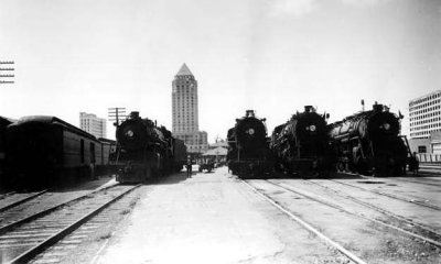 1927 or 1928 - four Florida East Coast Railway locomotives with the almost completed Dade County Courthouse in downtown Miami