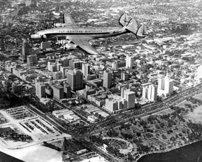 1950's - Eastern Air Lines Constellation over downtown Miami