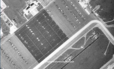 1963 - closeup aerial view of Homestead AFB with approximately 43 fighters on the northeast end of ramp