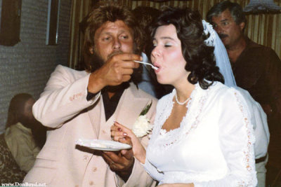 Terry feeding Susan some delicious wedding cake
