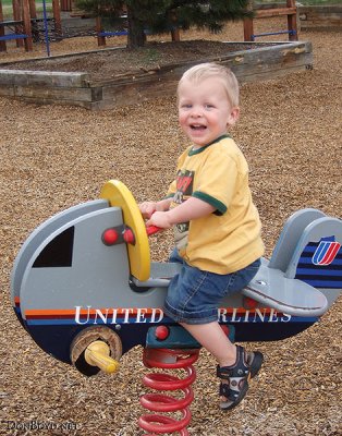 July 2007 - Kyler having fun on United Airlines springy airplane at Palmer Park