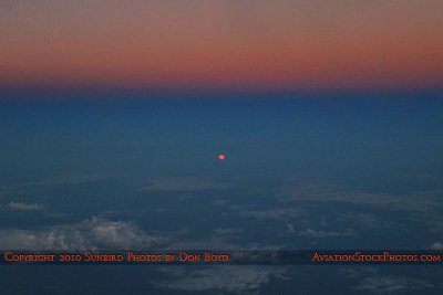 2010 - the Harvest Moon rising at the same time the sun was setting while inflight