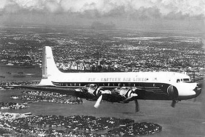 1950's - Eastern Air Lines DC-7B over Miami Beach
