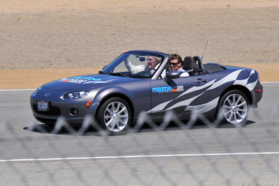 Dan Gurney, 79, being driven by son Alex around the Mazda Raceway Laguna Seca in a Mazda MX-5 Miata. (CR)