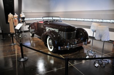 1937 Cord 812 Convertible Coupe, with period undergarments that helped make streamlined silhouettes in fashion possible