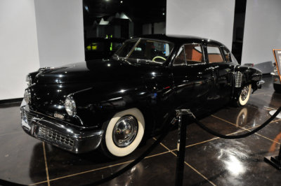 1948 Tucker, with advanced features, such as seat belts, rear-mounted engine, central headlight that turned with front wheels