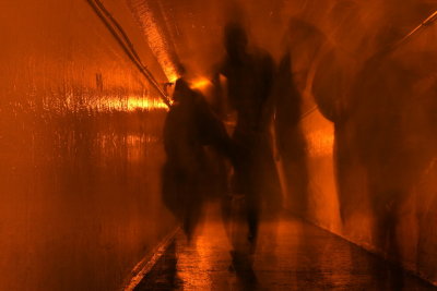 People walking through a tunnel below the Niagara Falls