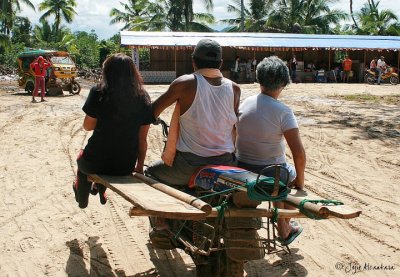 My first taste (me on left side wearing black shirt and holding on for dear life) of the local transportation called SKYLAB (motorcycle with wood planks tied together as passenger seats), a death defying experience in Surigao del Sur, 2008.