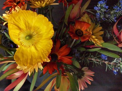 Dying flowers in a black rubber vase at sunset