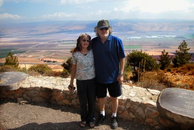 Judy and Richard in the Neftali Mountains overlooking the Hula Valley with the Golan Heights across the Valley in the background
