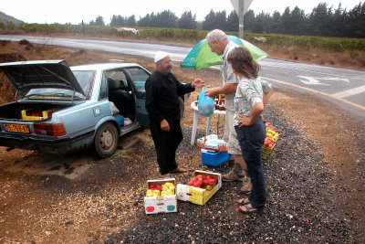 Moshe purchasing apples and Judy purchasing home-made jelly from a Druze Arab on the side of the road in the Golan Heights