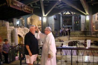 Nazareth: The Basilica of the Annunciation: Priest blessing people as they leave the lower church where the grotto is located.