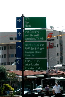 Street sign in Nazareth indicating how to get to different cities, towns and roads. Sign is in Hebrew, Arabic and English