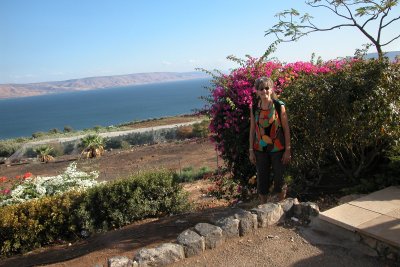 Judy at the Sea of Galilee with mountains in Jordan in the background.