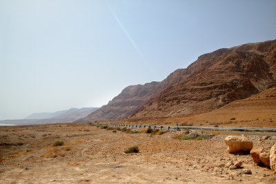 Road to Masada and the Dead Sea in the Judean Desert with beautiful cliff formations. The Dead Sea is to the left.