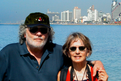 Judy and Richard on the promenade in Jaffa - Tel Avivs skyline and the Meditteranean Sea are in the backgorund.
