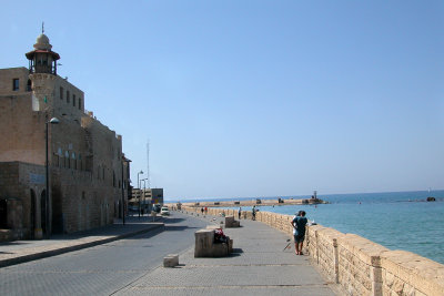 Fisherman along the Mediterranean Sea in Jaffa. The entrance to the Jaffa port is in the background.