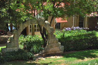 A  Moon Gate leads down to the Chapel and house