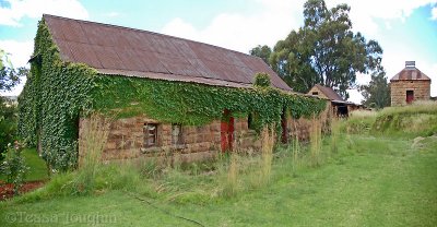 Beautiful sandstone shed covered in creeper