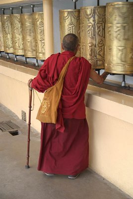Tibetan Monk Turning Mani Prayer Wheel