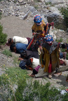 Monks Stepping over Prostrated Devotees