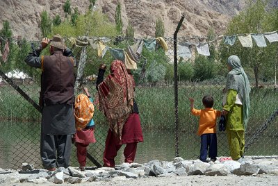 Locals Looking at Holy Fish Pond Shey