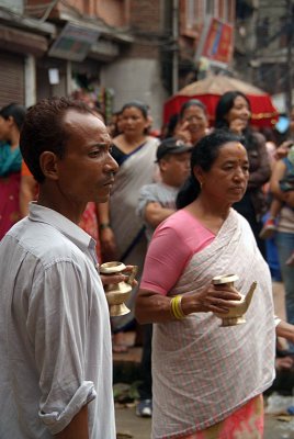 Man and Woman with Jugs of Milk for Participants in Gai Jatra