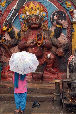 Woman with Umbrella in front of Kala Bhairab Statue Durbar Square