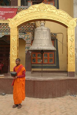 Monk with Alms Bowl Outside Monastery Boudha