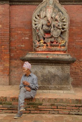 Old Man Sitting in front of Ganesha Statue Durbar Square Patan