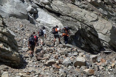 Trekkers Climbing over Landslide