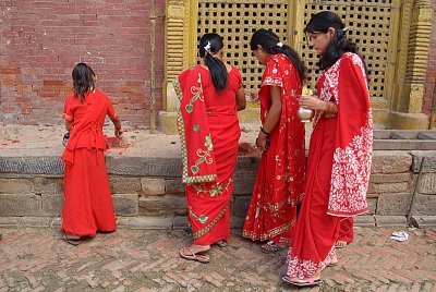 Women in Red Saris at Chobar Temple