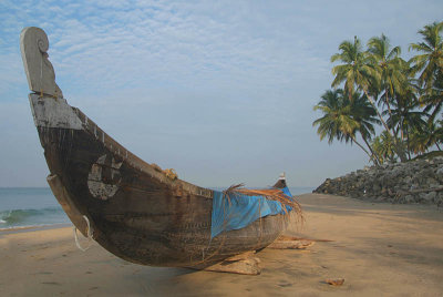 Boat and Palms on Black Beach Varkala