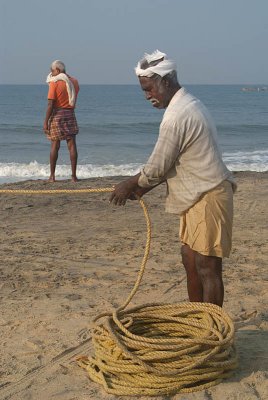 Fishermen Pulling in Nets Black Beach 02