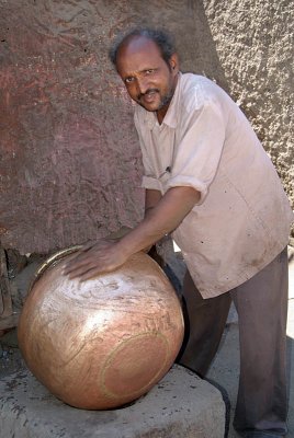 Man Polishing a Pot Bijapur