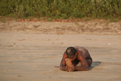 Indian Man doing Yoga on Beach