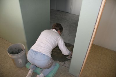 Carol finishing the grout work on the master bath tile