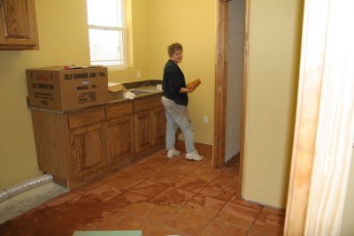 Carol is grouting the laundry room