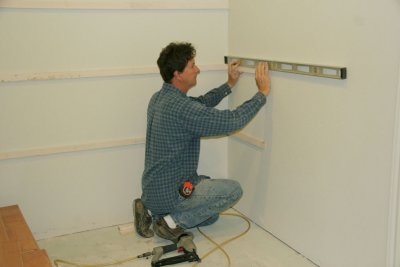 Paul is putting up shelving in the master closet