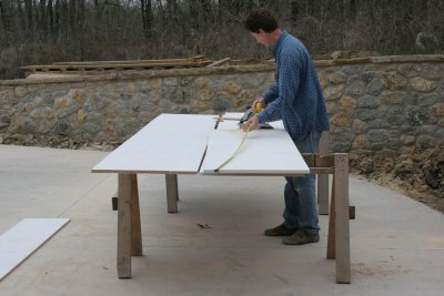 Paul cutting shelving material on the newly poured driveway