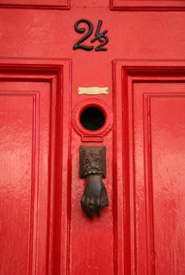 Hand Knocker on Red Door