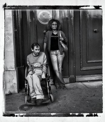 A disabled spectator at the final of the Tour de France with his supporter