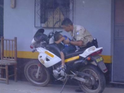 The cop needed his bike but didn't want to wake this little guy up.