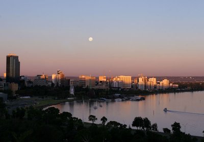 Sun setting as gibbous moon rises over Perth Water