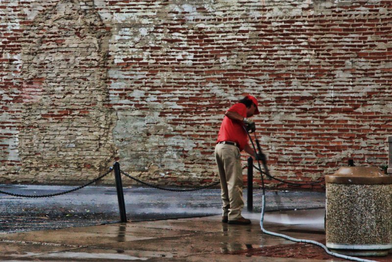 CLEANING THE SIDEWALK