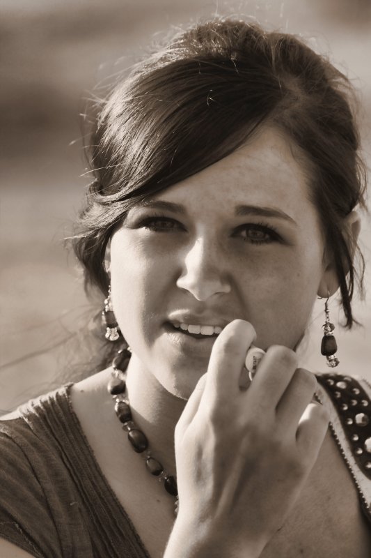 GIRL FIXING TO PUT ON SOME CHAPSTICK